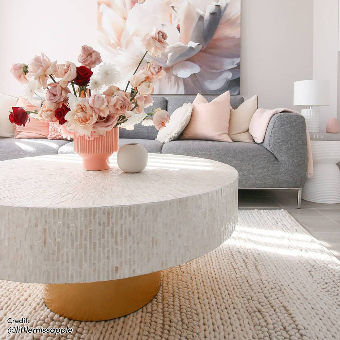 Abelene 91cm Pearl Inlay Coffee Table - Cream, featuring an intricate mother of pearl mosaic top with a cylindrical gold pedestal, showcased in a cozy living room setting with surrounding decor.