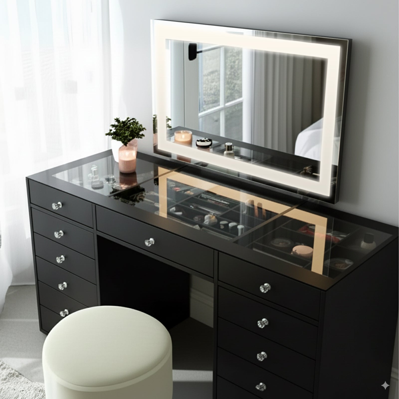 Adeline Makeup Vanity Table with LED Mirror in Black features a glossy black desk, LED-lit mirror, organized cosmetics, and a cream ottoman, creating a stylish, elegant dressing area.