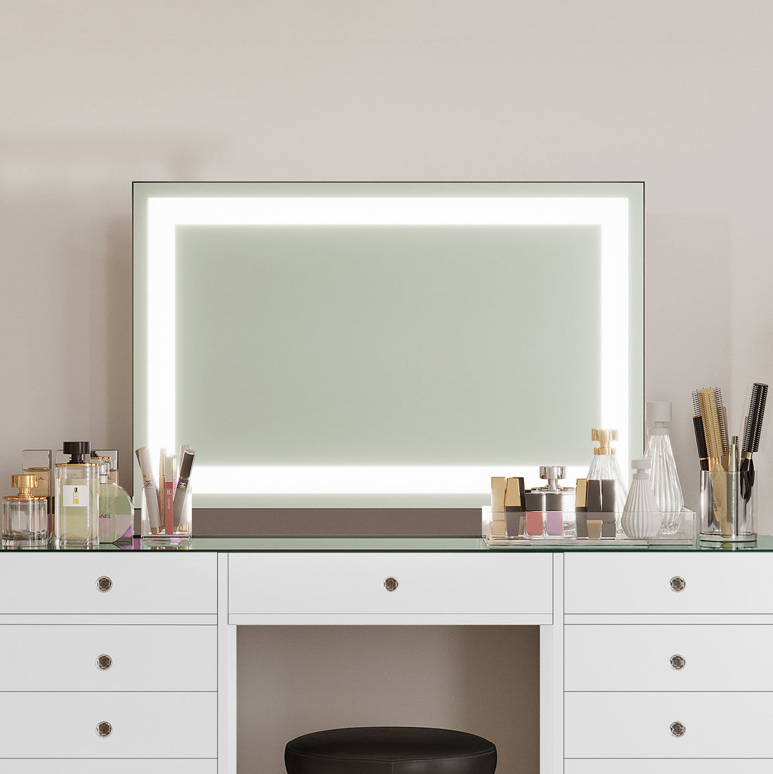 Adeline Wall Mount Touch Screen Mirror with LED Light in White, featuring a sleek, illuminated frame above a glass-topped white drawer, surrounded by organized beauty essentials on a minimalist vanity setup.