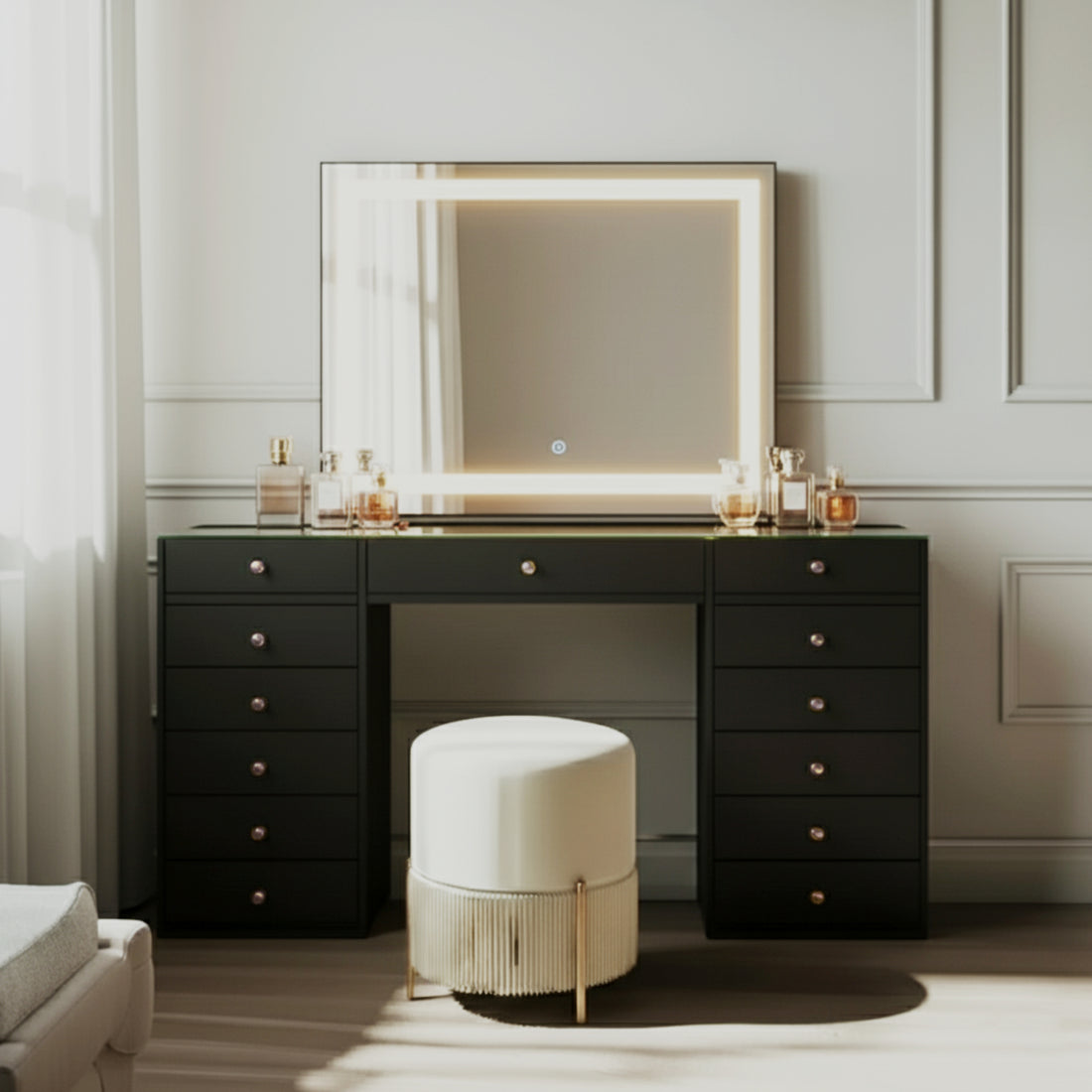 Adeline Makeup Vanity Table with LED Mirror in Black features a sleek design with spacious storage, warm LED-lit mirror, arranged cosmetics, and a plush ottoman stool, perfect for a chic beauty setup.
