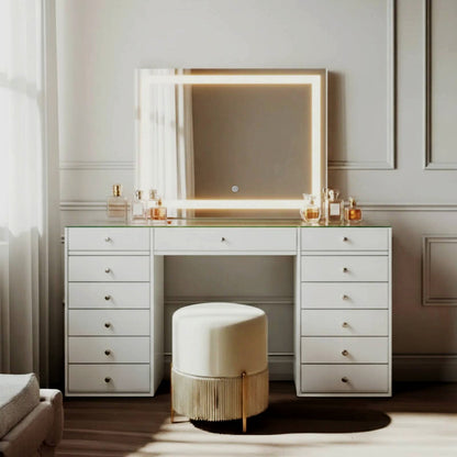 Adeline LED Mirror Storage Dressing Table in White, featuring a wide desk with 13 drawers, a large LED-framed mirror, and a glass top adorned with perfume bottles, paired with a cream stool.