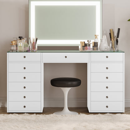Adeline Glass Top Storage Makeup Dressing Table Desk in White featuring a large LED mirror, multiple drawers, perfume bottles, makeup containers, and a black-cushioned stool on a plush rug.