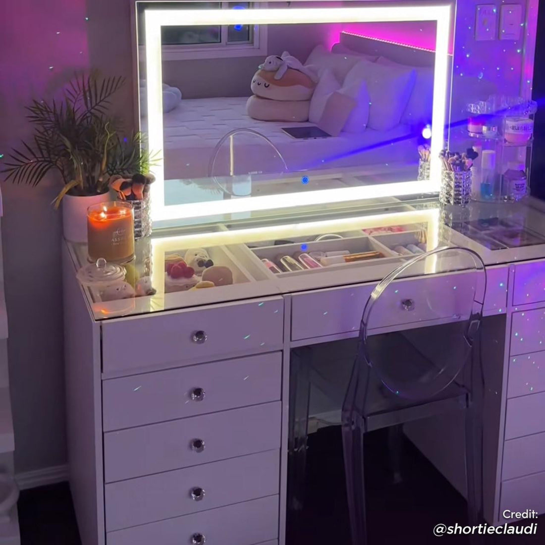 Adeline LED Mirror Storage Dressing Table in White features a lit mirror with acrylic chair, makeup brushes, skincare organizer, and glass-top compartments in a softly lit bedroom corner.