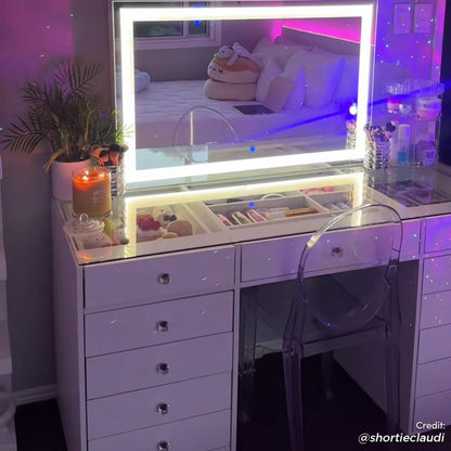 Adeline LED Mirror Storage Dressing Table in White features a lit mirror with acrylic chair, makeup brushes, skincare organizer, and glass-top compartments in a softly lit bedroom corner.