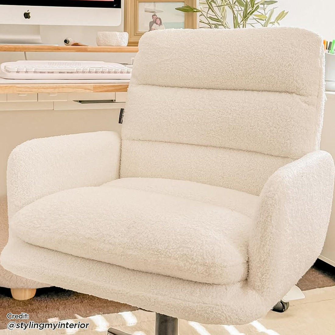 Luxo Aglaya Boucle Swivel Office Chair in Cream White, featuring plush, upholstered design with padded armrests, cushioned seat and backrest on a swivel base, set in a stylish home workspace.