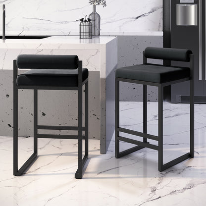 Aivy Velvet Bar Stool Black Set of 2 featuring soft velvet upholstery, thick foam padding, and a sleek matte black metal frame with footrest, shown in a modern dining setting.