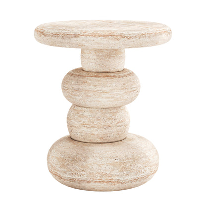 Amalee 40cm Round Indoor/Outdoor Concrete Side Table Travertine features stacked pebble-shaped stone elements, creating a sculptural, cairn-like appearance with a smooth round top, ideal for stylish indoor settings.