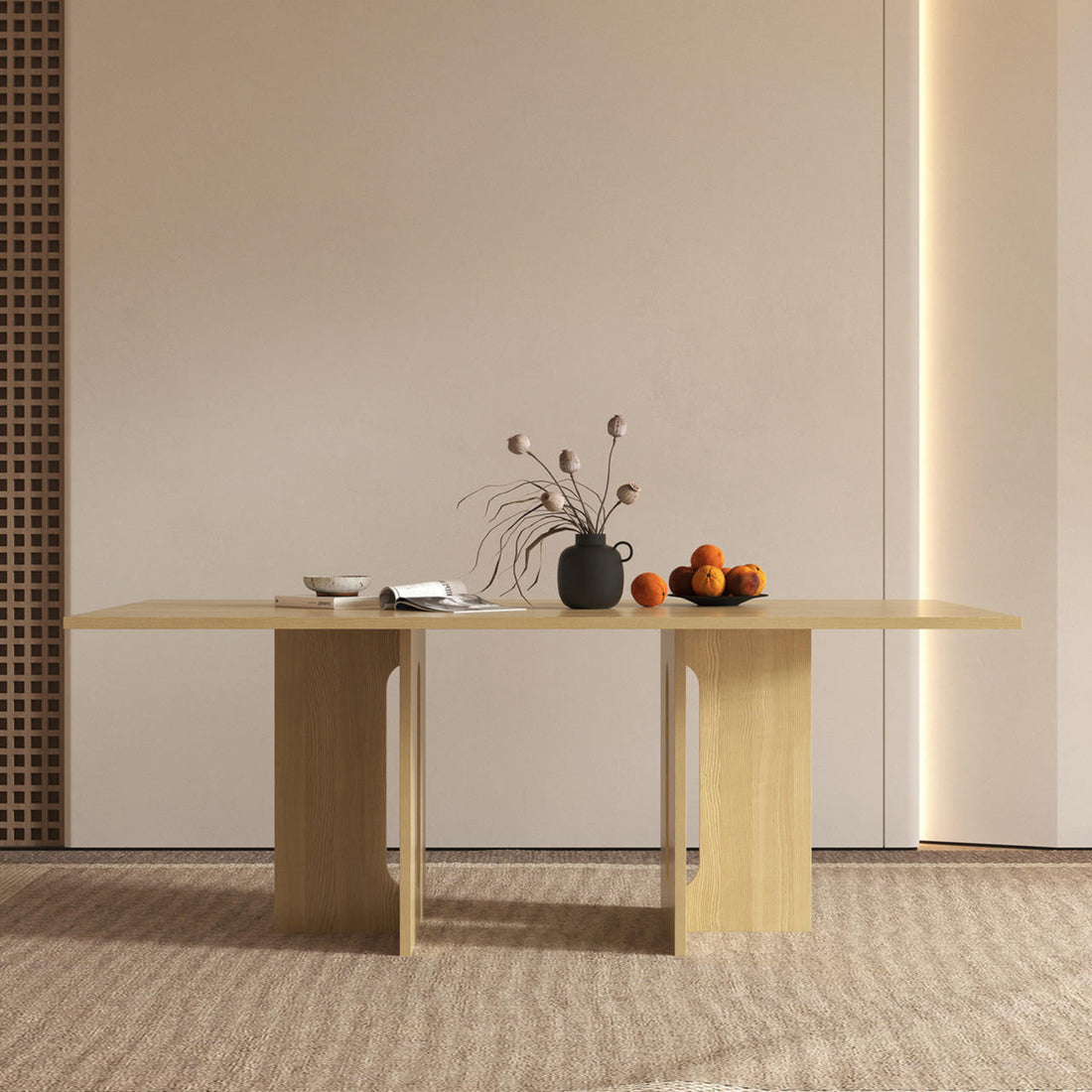 Amora 200cm Dining Table - Natural with a light-wood T-leg base, featuring a matte-black vase, shallow dish, open magazine, and a black plate with oranges on top.