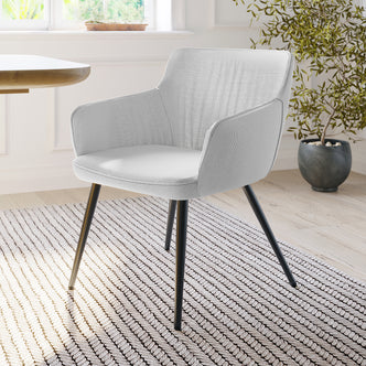 Anthony Linen Dining Chair with Arms Set of 2 in Light Grey, featuring light gray upholstery, black metal legs, set beside a wooden table on a neutral rug, with a potted plant nearby.