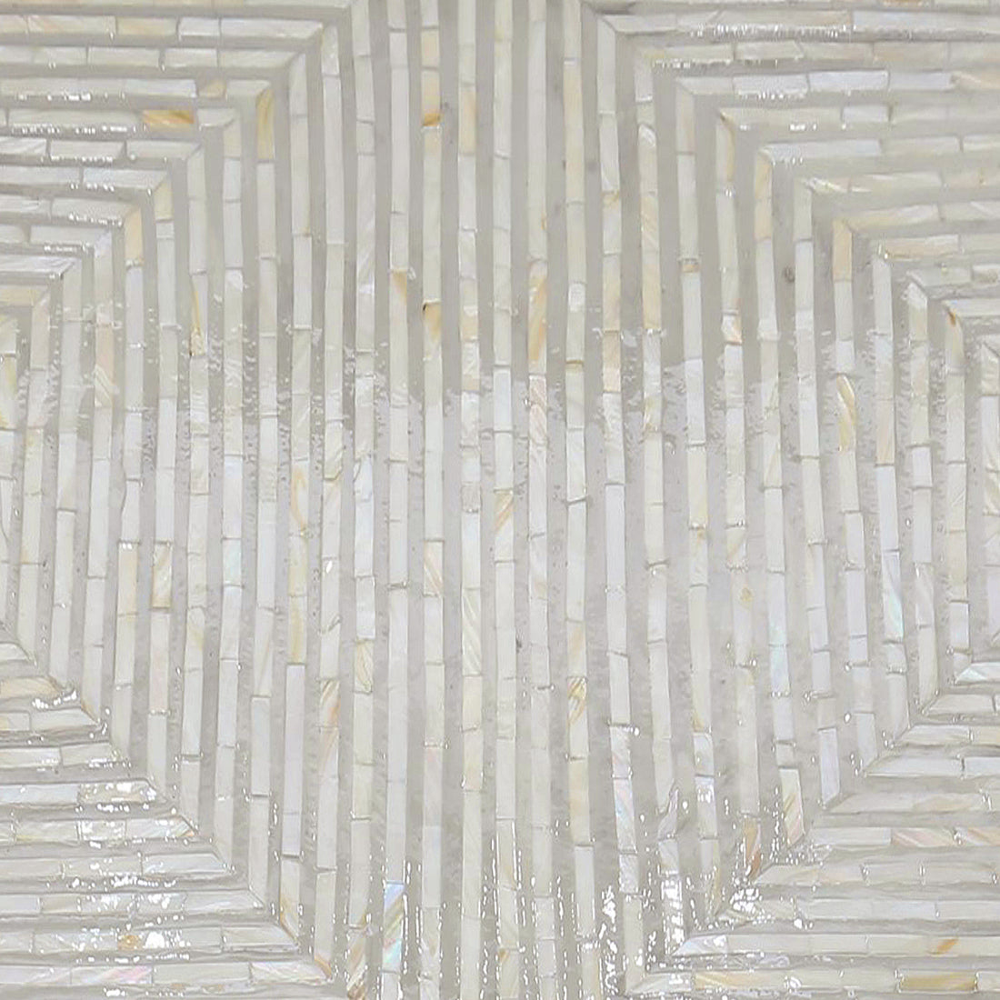 Audino Mother of Pearl Inlay Coffee Table in Ivory & Grey, showcasing a geometric mosaic pattern of glossy, narrow tiles with a pearly sheen, forming concentric hexagons, ideal for elegant interior décor.