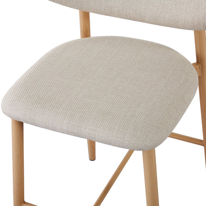 Audrey Curved Linen Barstool Set of 2 in Beige features a close-up of a beige upholstered seat on a light-stained wooden frame, showcasing its modern, minimalist design.