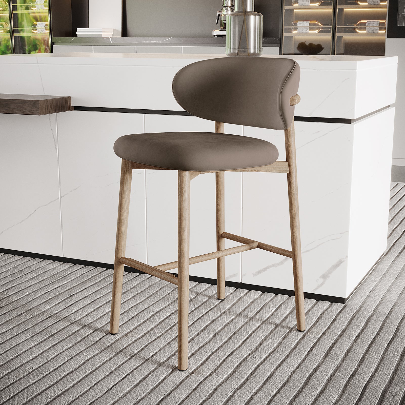 Audrey Velvet Fabric Upholstered Barstool Set of 2, featuring a light wood frame with curved backrest and padded seat, elegantly positioned at a white marble kitchen island in a modern setting.