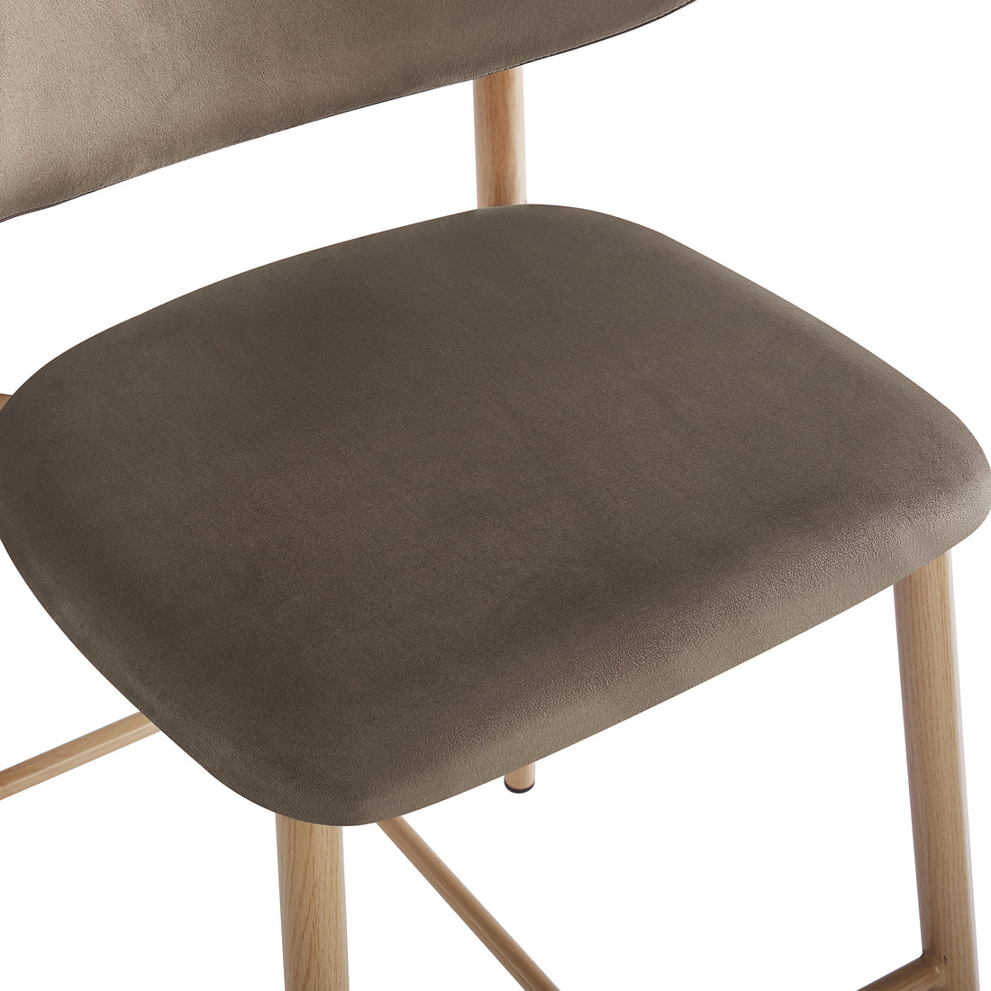 Close-up of the Audrey Velvet Fabric Upholstered Barstool, featuring a cushioned seat and backrest in brown velvet, mounted on natural-finish wooden legs with cross-support, highlighting contemporary elegance and comfort.
