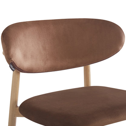 Close-up of the Audrey Velvet Fabric Upholstered Barstool Mocha Mousse Set of 2, featuring a wooden frame, brown upholstered cushions, and sleek metal legs with wood-look finish.