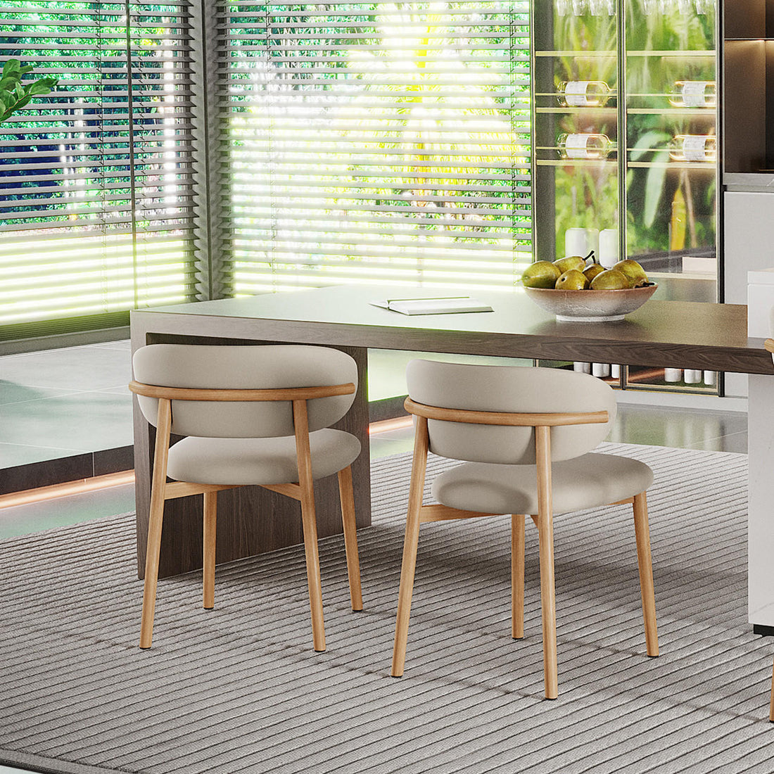 Audrey Curved Fabric Dining Chair Set of 2 in Beige, featuring light-beige upholstery and light wood frames, paired with a wooden table, set against floor-to-ceiling windows with Venetian blinds.