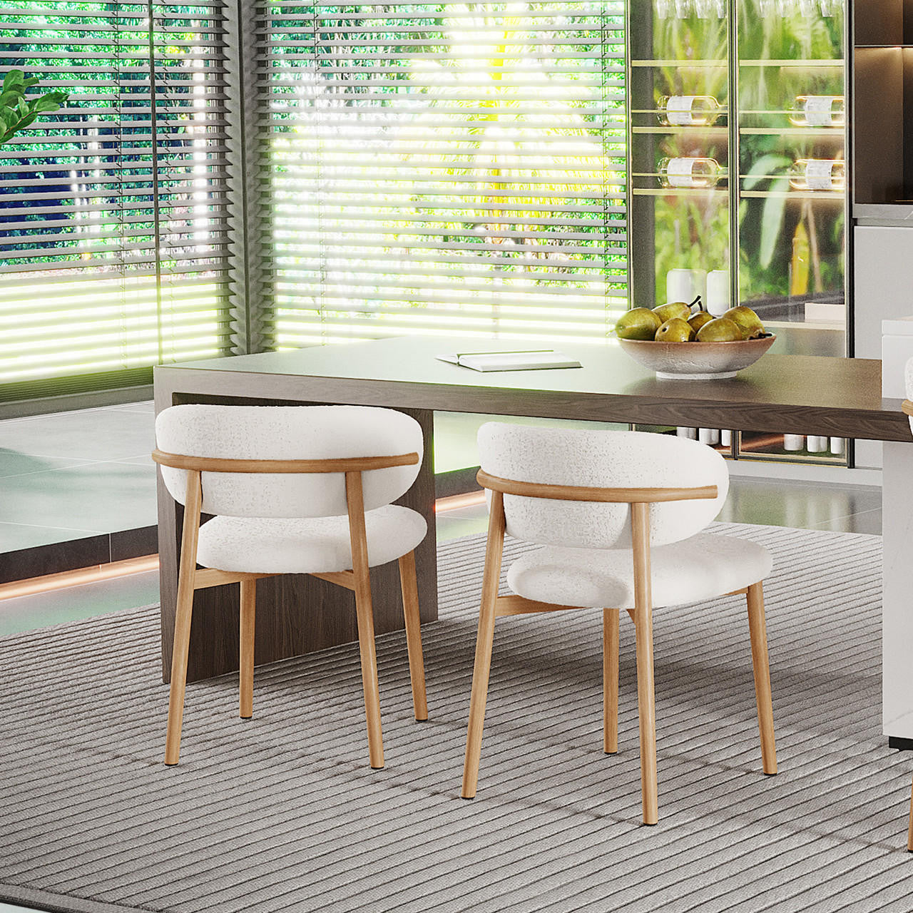 Audrey Curved Fabric Dining Chair Set of 2 in Cream White, featuring soft bouclé upholstery, gold chrome legs, and curved backrests, placed around a wooden table with pears and a notebook.