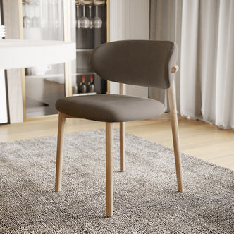 Audrey Fabric Dining Chair Espresso Brown Set of 2 shown in a modern setting, featuring curved backrest, four light-wood legs, and smooth upholstery, positioned on an area rug with light wood flooring.