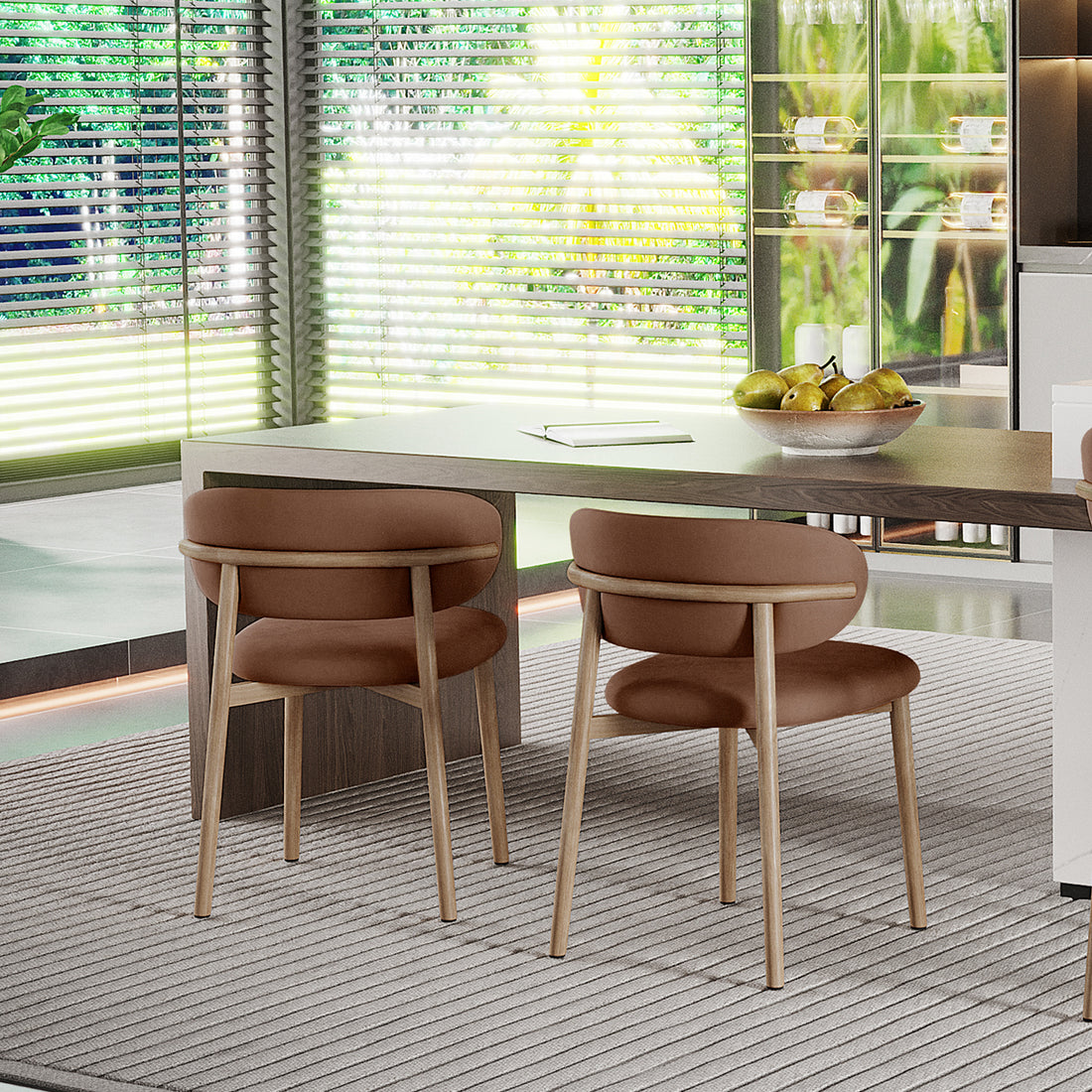 Audrey Fabric Dining Chair Mocha Mouses Set of 2 in a dining nook, featuring light-wood chairs with rounded cushions at a wooden table, beneath a neutral-tone area rug, framed by large windows.