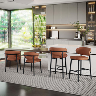 Audrey Curved Bar Stool & Dining Chair Set of 4 in Tan, featuring rust-brown upholstery on black metal frames, arranged around a white marble island and dining table in a modern open-plan kitchen.