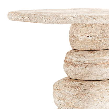 Close-up of Azalea Round Indoor/Outdoor Concrete Dining Table Travertine, showcasing its pebble-shaped travertine blocks forming a small, round side table with a flat, circular top.