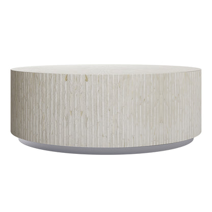 Baltoy 100cm Mother of Pearl Inlay Coffee Table in Sand, featuring a drum shape with a subtly textured off-white surface and sophisticated stripe pattern, set on a thin recessed gray base.
