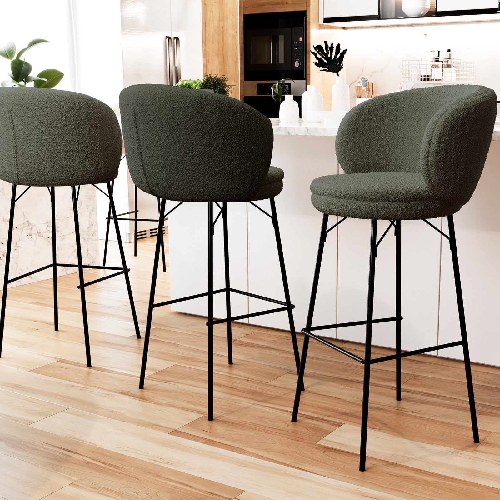 Belize High Back Boucle Bar Stool Set of 2 in Green features curved boucle seats, black metal legs, and footrests, arranged at a modern kitchen island with marble countertop and wood-tone cabinets.