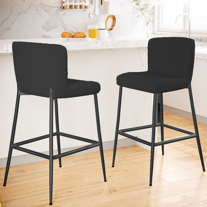 Bernie High Back Boucle Bar Stool Set of 2 in Black featuring plush, curved seats and backs, metal frames with footrests, placed in a modern kitchen with a white marble countertop island.