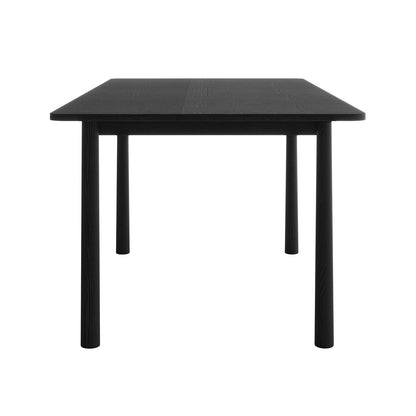 Side view of the Luxo Living Bijan black solid oak dining table in its non-extended 150cm configuration, showcasing its compact size and minimalist design on a white background.