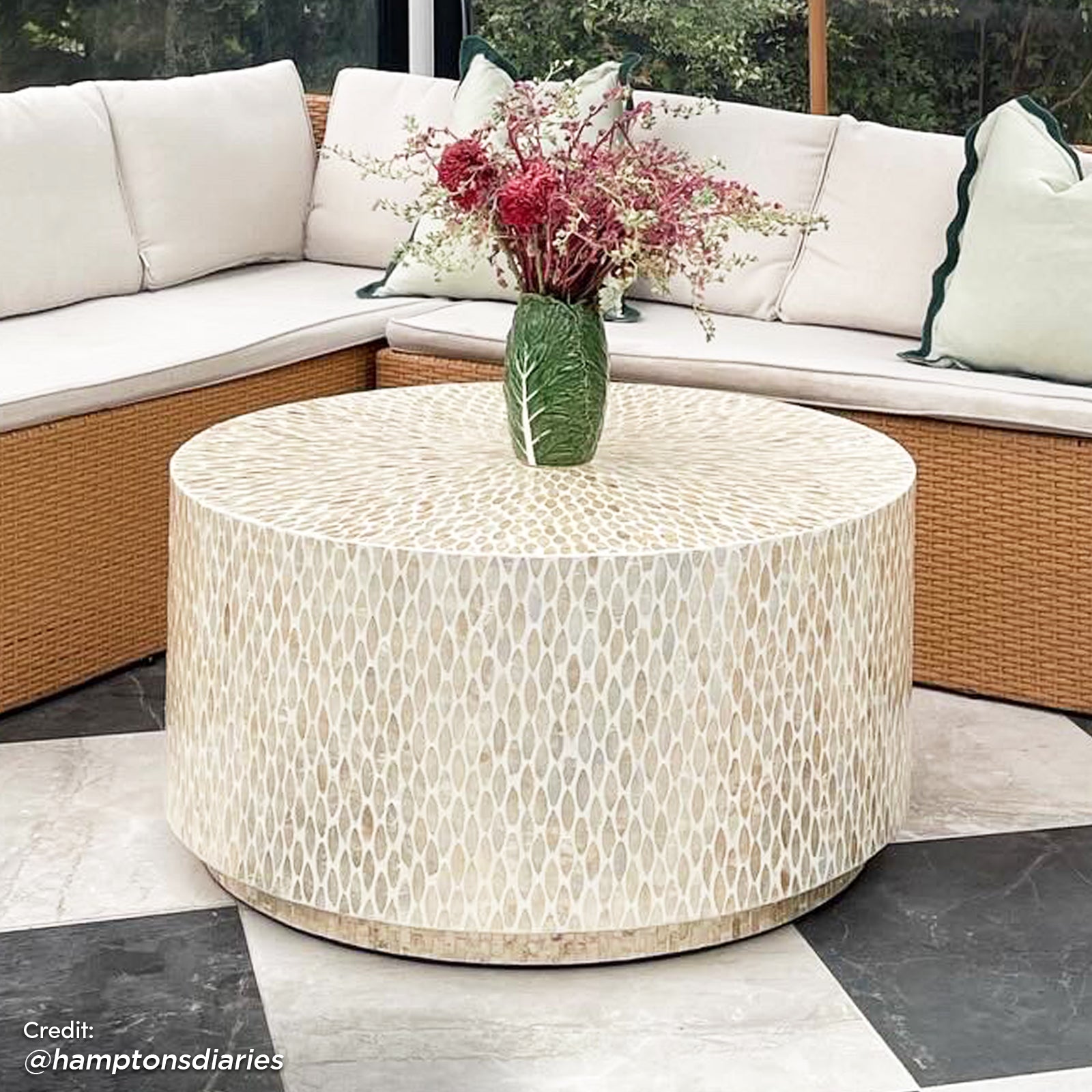 Close-up of the Bisera 91cm Mother of Pearl Inlay Coffee Table, featuring a hand-crafted mother-of-pearl mosaic design on the tabletop, set in a living room setting with a couch and vase nearby.