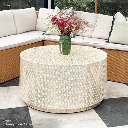 Close-up of the Bisera 91cm Mother of Pearl Inlay Coffee Table, featuring a hand-crafted mother-of-pearl mosaic design on the tabletop, set in a living room setting with a couch and vase nearby.