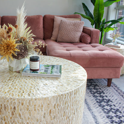 Bisera 91cm Mother of Pearl Inlay Coffee Table Beige, showcasing intricate mother-of-pearl mosaic detailing on its surface, set atop a stack of magazines, emphasizing its elegant craftsmanship and luxurious design.