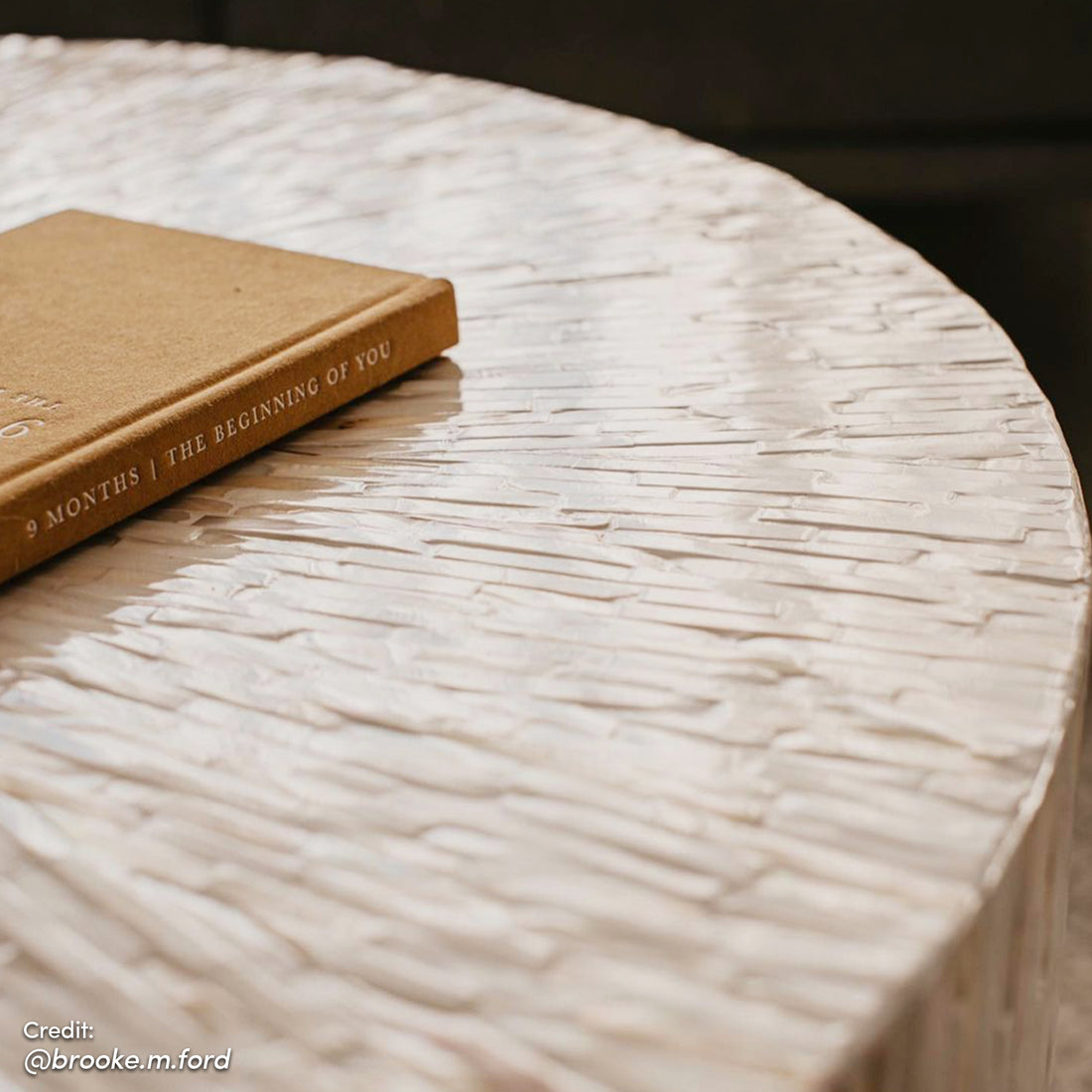 Bisera 91cm Mother of Pearl Inlay Coffee Table displayed indoors on a wooden surface, showcasing its intricate hand-crafted mother-of-pearl mosaic design, emphasizing its use as a luxurious centerpiece.