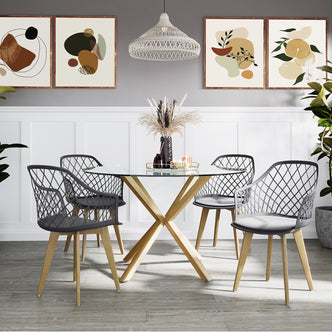Caesar Beech Dining Chair Set of 4 in Dark Charcoal around a glass-top table, featuring molded seats, open-mesh backs, and wooden legs with metal caps, in a modern dining-room setup.