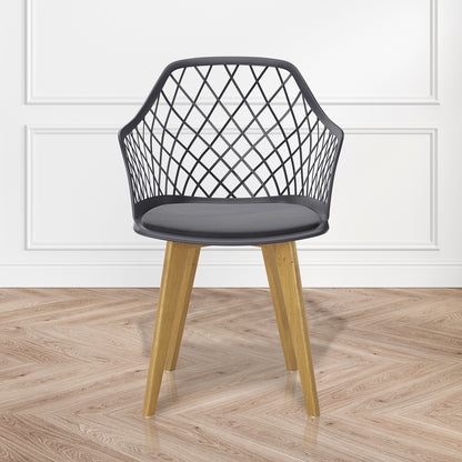 Caesar Beech Dining Chair Set of 4 in Dark Charcoal features a modern black lattice-patterned plastic seat with a velvet cushion, supported by sturdy beech wood legs, ideal for stylish dining spaces.