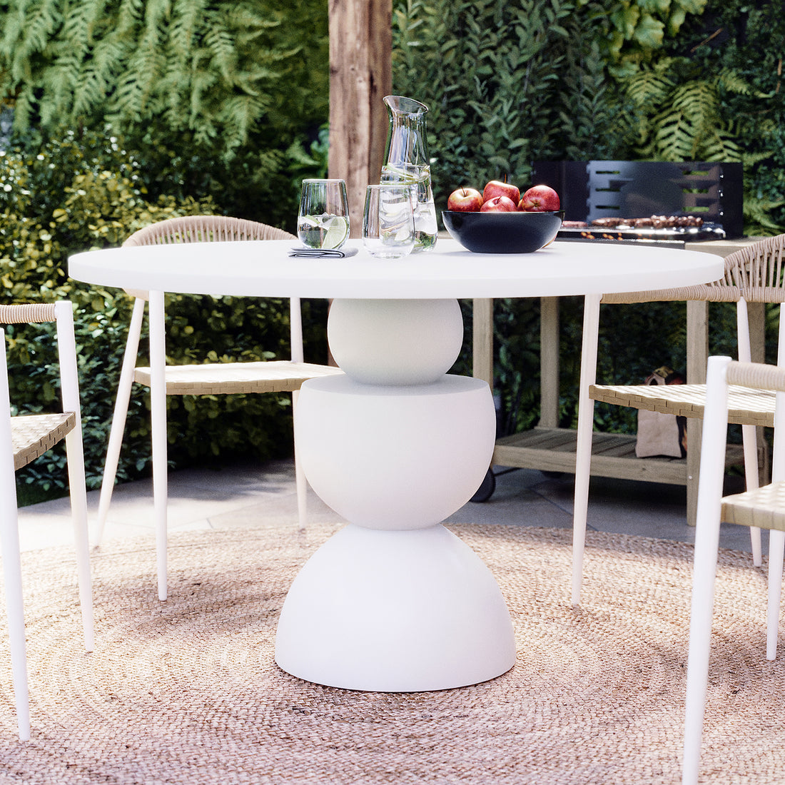 Carmen 120cm Indoor-Outdoor Concrete Dining Table - White, featuring a round top on a curvy artistic base, ideal for versatile dining settings.