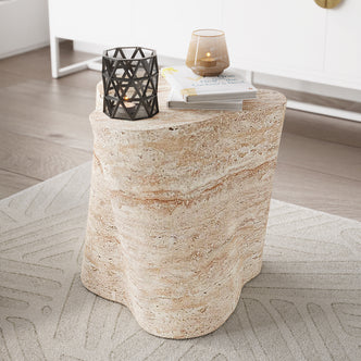 Cayton Concrete Indoor Side Table - Travertine featured with a smooth, rounded design, resembling natural stone, sturdily holding a candle and book; exudes modern elegance and durability in indoor settings.
