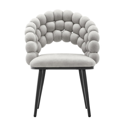 Claudine Velvet Curved Dining Chair Set of 2 in Warm Grey features a padded light-beige seat, distinctive bubble-style backrest with tufted cushions, and sleek black legs for a modern touch.