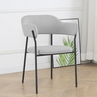 Clavin Fabric Dining Chair Set of 2 in Light Grey, features a modern design with padded upholstery, curved backrest, and slender black metal legs. Positioned in a minimalist setting with a palm print backdrop.