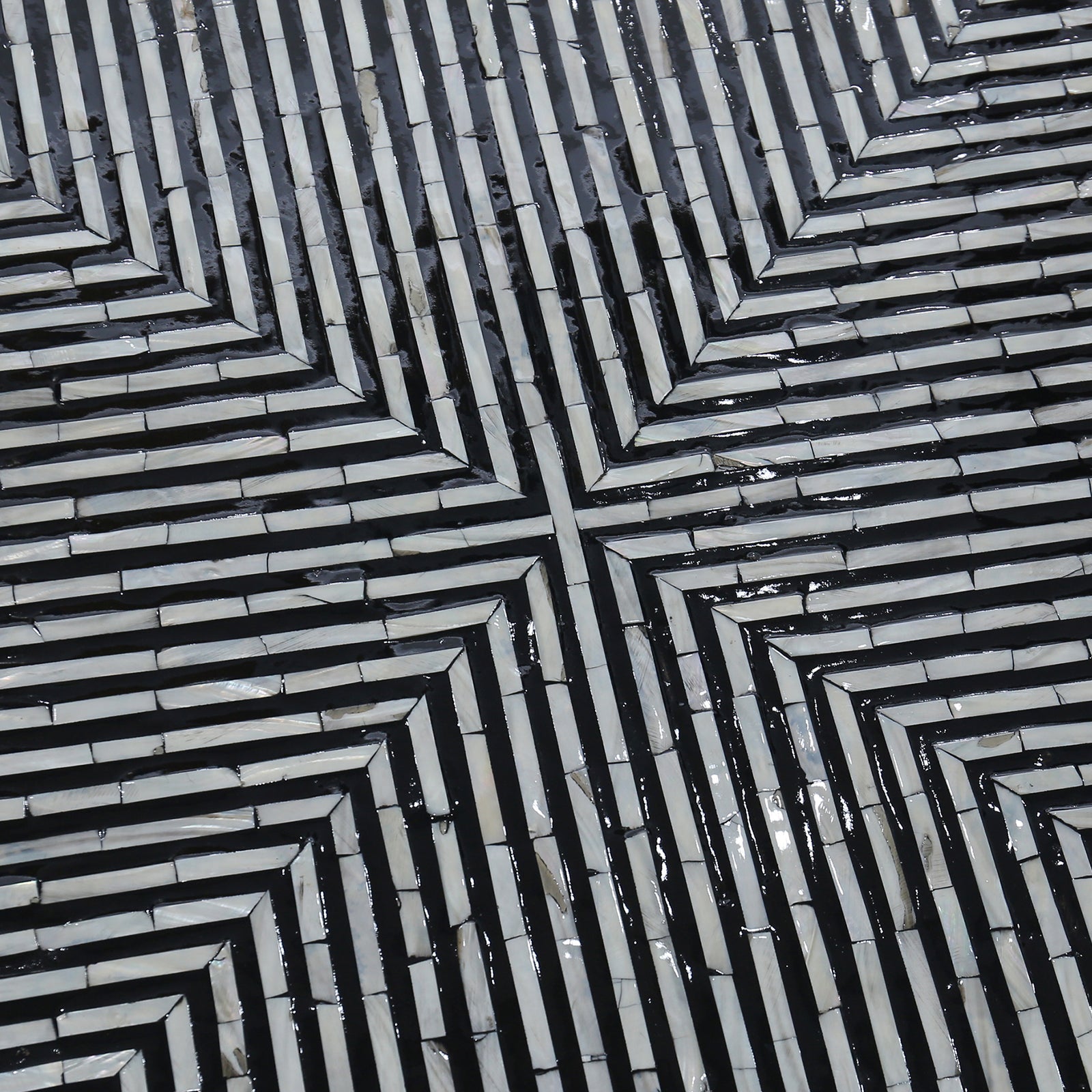 Cradily Mother of Pearl Inlay Coffee Table features a geometric, labyrinth-like mosaic pattern with light tiles and dark grout, forming a square spiral design, showcasing its intricate craftsmanship and elegant centerpiece appeal.