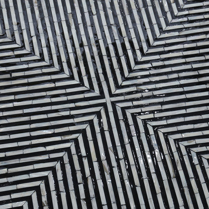 Cradily Mother of Pearl Inlay Coffee Table features a geometric, labyrinth-like mosaic pattern with light tiles and dark grout, forming a square spiral design, showcasing its intricate craftsmanship and elegant centerpiece appeal.