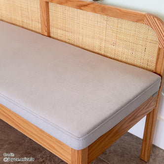 Close-up of the Dana 120cm Solid Oak Hardwood Bench - Natural, highlighting its solid oak frame, natural rattan backrest, and fabric-covered cushioned seat, emphasizing its sturdy construction and comfortable design.