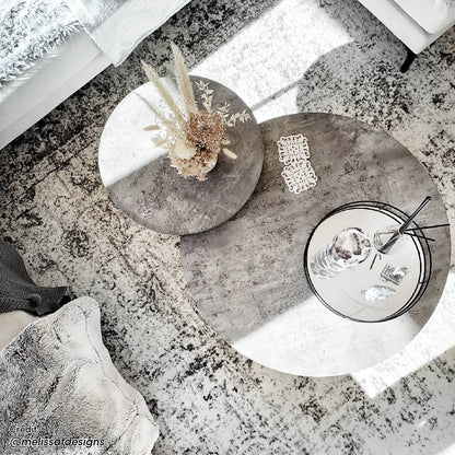 Earl Nesting Coffee Table Set of 2 - Concrete shown with a round, smooth tabletop and sturdy metal frame, emphasizing its modern, versatile design in a living space setting.