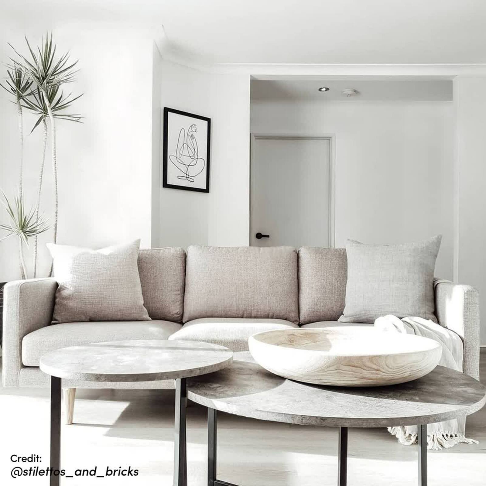 Earl Nesting Coffee Table Set of 2 - Concrete, featuring round tabletops on a sturdy metal frame, stylishly displayed in a modern interior setting alongside cozy furniture and decorative elements.