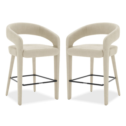 Eisha Velvet Bar Stool Beige Set of 2 features sleek white chairs with black legs, armrests, and a built-in footrest, offering elegant style and comfort for dining or bar areas.