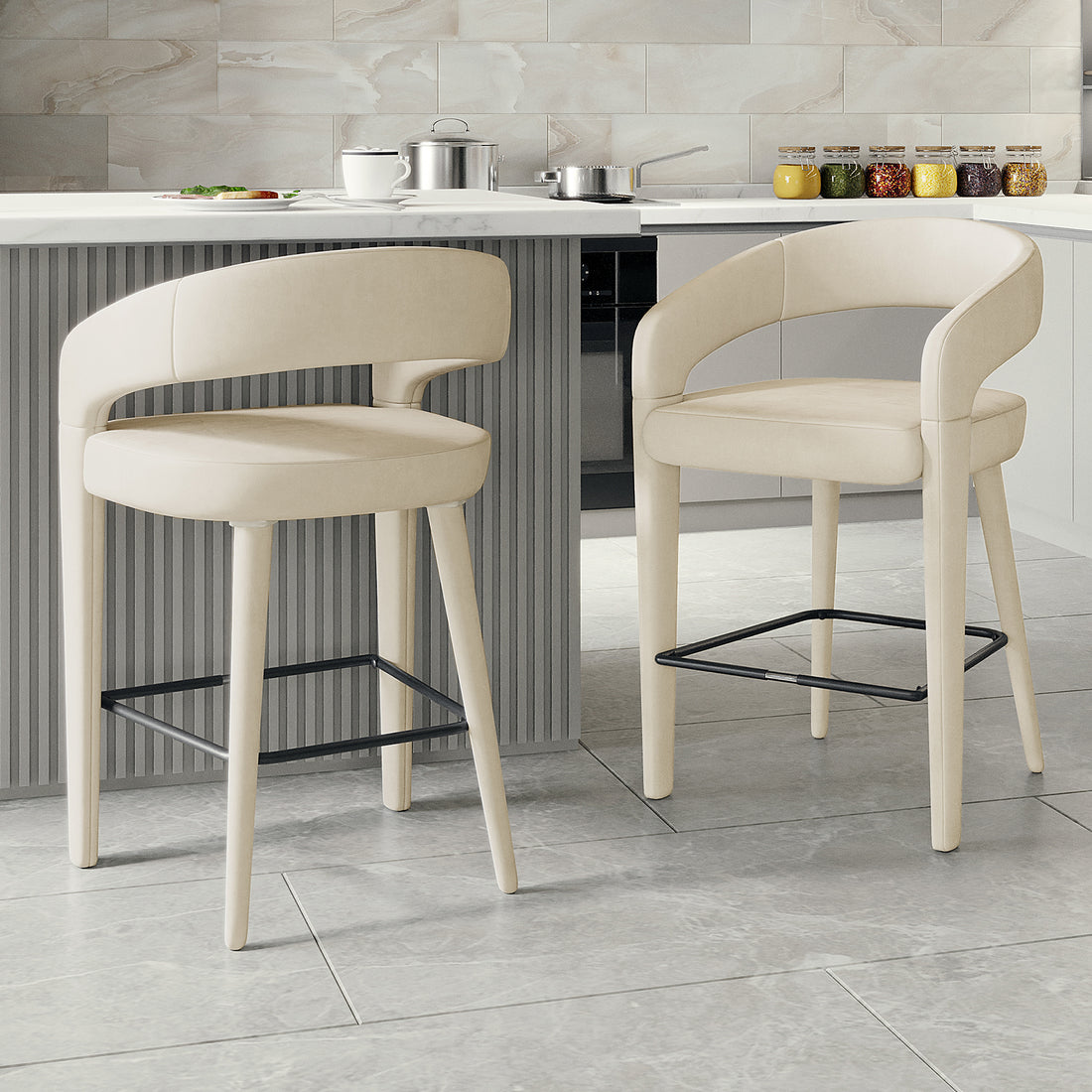 Eisha Velvet Bar Stool Beige Set of 2, showcasing luxurious velvet fabric, curved back with armrests, and a built-in footrest, positioned in a modern kitchen setting with sleek, durable design elements.