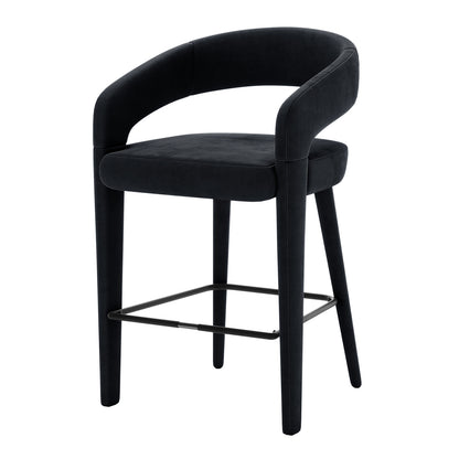 Eisha Velvet Bar Stool Black Set of 2 features a sleek, curved back design with luxurious velvet upholstery and comfortable foam padding, enhancing modern dining or bar areas with style and elegance.