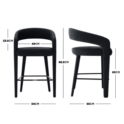 Eisha Velvet Bar Stool Black Set of 2 features a sleek design with curved backs and armrests, upholstered in velvet, and supported by a sturdy metal frame with built-in footrests, ideal for modern interiors.