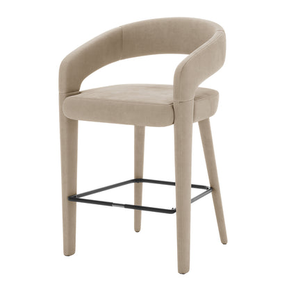 Eisha Velvet Bar Stool Warm Grey Set of 2 features a plush, fully upholstered velvet seat with curved back and armrests, sturdy metal frame, and built-in footrest, perfect for dining or bar areas.