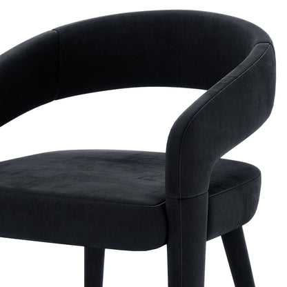 Eisha Velvet Dining Chair Black Set of 2, featuring plush velvet upholstery, curved backrest, armrests, and footrest on a sturdy metal frame with anti-slip pads for enhanced support and comfort.