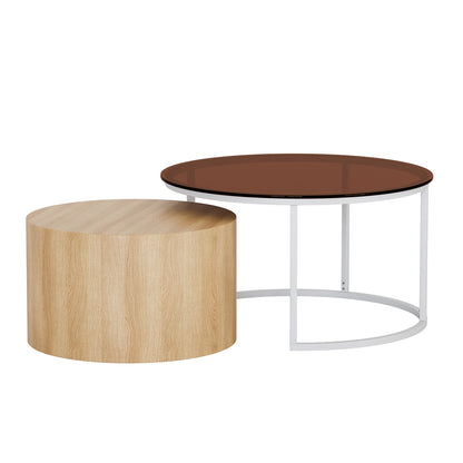 Ellisha Round Nesting Coffee Table in Natural featuring a solid-wood cylinder and a larger table with a white metal frame and brown-tinted glass top, showcasing a contemporary, mixed-material design.